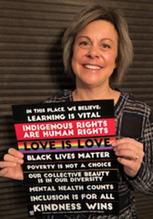 This image has an empty alt attribute; its file name is Amy-and-poster.jpg